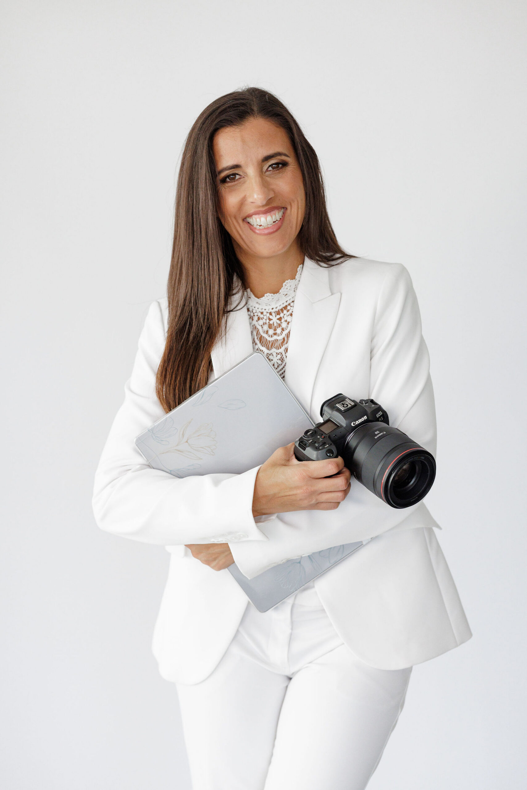 Jo Espejo brand strategist and photographer holding camera and laptop for Branding by Jo
